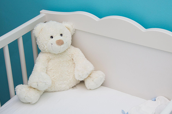 Teddy bear in a crib