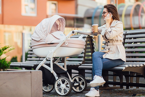 A mother with a newborn baby in a lightweight stroller