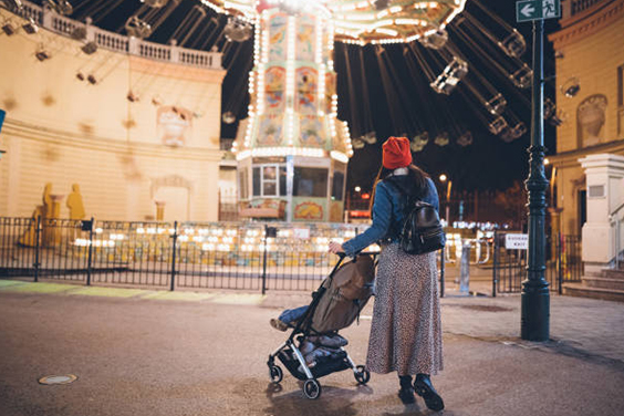 Mom and child in a stroller in the theme park