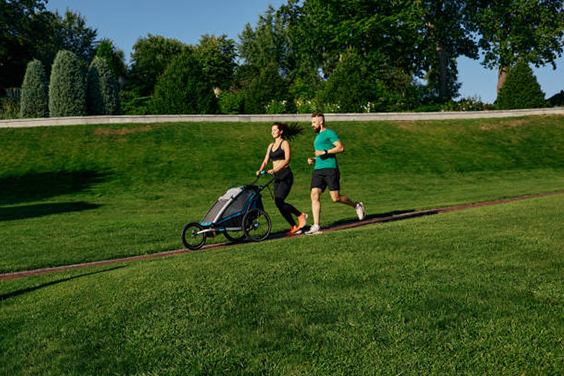 Parents Jogging with their Kid in a Stroller