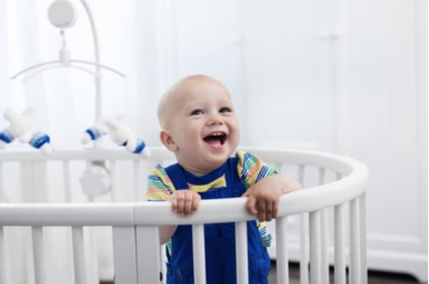 baby smile happily in a crib