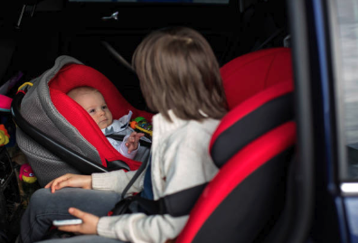 baby sit on the car seat in a car