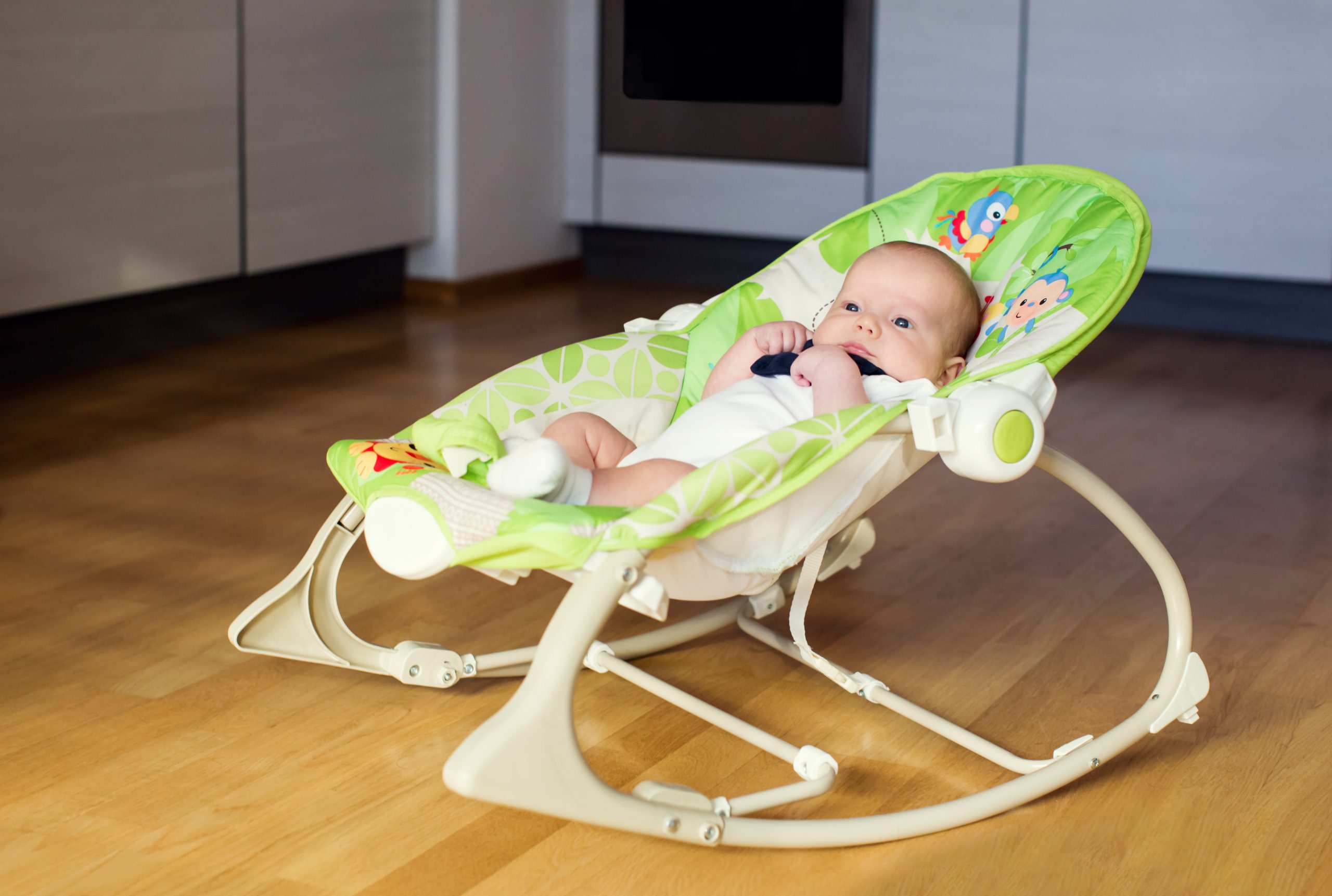 baby sleeps in the baby bouncer peacefully
